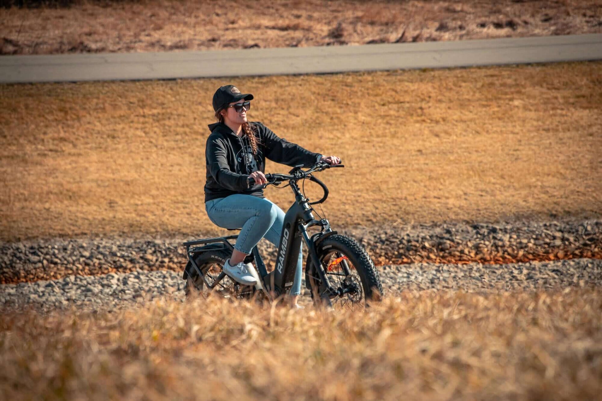 Person riding a Rambo Bikes SAVAGE 2.0 Electric Bike in a desert-like landscape